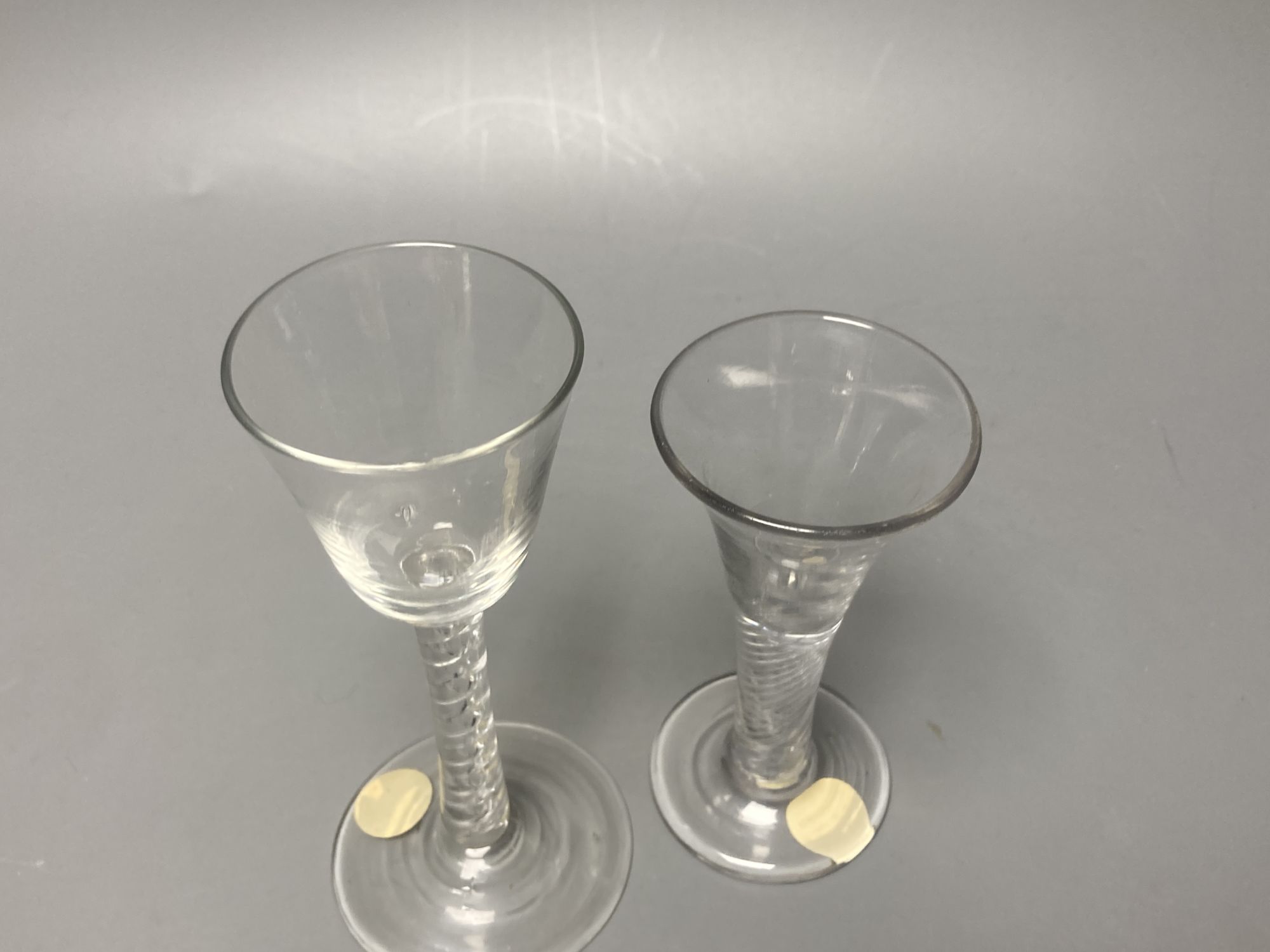 Two George II mercurial air twist stem cordial glasses, c.1750-5, with funnel and drawn trumpet bowls, 15.1cm and 12.4cm